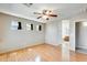 Hardwood bedroom with ceiling fan and archway to ensuite bathroom at 13536 W Peck Dr, Litchfield Park, AZ 85340