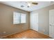 This bedroom features wood-look flooring, a window, ceiling fan and closet at 13536 W Peck Dr, Litchfield Park, AZ 85340