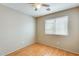 Bedroom with wood flooring, a window, ceiling fan, and neutral wall color providing a calming space at 13536 W Peck Dr, Litchfield Park, AZ 85340