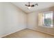 Bedroom with neutral carpet, a ceiling fan, and a window bringing in natural light at 13536 W Peck Dr, Litchfield Park, AZ 85340