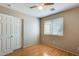 Bedroom features wood-look floor, a window, and a closet door; neutral wall color at 13536 W Peck Dr, Litchfield Park, AZ 85340