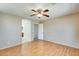 Bright bedroom with wood floors, ceiling fan, and ensuite bathroom access at 13536 W Peck Dr, Litchfield Park, AZ 85340