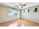 Bedroom with wood floors, ceiling fan, and multiple windows at 13536 W Peck Dr, Litchfield Park, AZ 85340