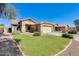 Well-maintained home with green lawn and desert landscaping for curb appeal at 13536 W Peck Dr, Litchfield Park, AZ 85340