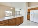 Neutral kitchen with wood cabinets and white refrigerator with water dispenser at 13536 W Peck Dr, Litchfield Park, AZ 85340