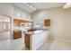 Bright kitchen with vaulted ceiling, light wood cabinets, and modern white appliances at 13536 W Peck Dr, Litchfield Park, AZ 85340