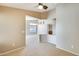 Open-concept living space featuring neutral carpet and arched entryway into dining area at 13536 W Peck Dr, Litchfield Park, AZ 85340