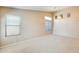 Bright, neutral living room featuring multiple windows and neutral carpeting at 13536 W Peck Dr, Litchfield Park, AZ 85340