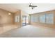 Bright living room featuring tile flooring, a ceiling fan, and sliding glass doors at 13536 W Peck Dr, Litchfield Park, AZ 85340