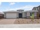 Charming single-story home featuring a two-car garage and meticulously xeriscaped front yard at 13757 W Forest Pleasant Pl, Peoria, AZ 85383