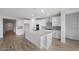 Bright kitchen with white cabinets, a spacious island, and stainless steel appliances at 13757 W Forest Pleasant Pl, Peoria, AZ 85383
