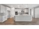 Modern kitchen features white cabinets, stainless steel appliances, and a large island at 13757 W Forest Pleasant Pl, Peoria, AZ 85383