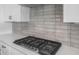 Close-up of the stove and countertops in the kitchen with backsplash tile at 13757 W Forest Pleasant Pl, Peoria, AZ 85383