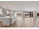 Sun-filled view of the open kitchen with a center island, modern fixtures, and a living area at 13757 W Forest Pleasant Pl, Peoria, AZ 85383