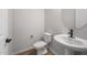 A well-lit powder room with wood-look flooring, modern sink, and sleek black faucet at 13757 W Forest Pleasant Pl, Peoria, AZ 85383