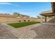 Well-maintained backyard features artificial turf, gravel, brick wall, and covered patio at 19862 E Carriage Way, Queen Creek, AZ 85142