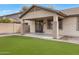 Charming backyard features a covered patio and manageable artificial turf at 19862 E Carriage Way, Queen Creek, AZ 85142