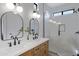 Beautiful bathroom with dual sinks, framed mirrors, and glass-enclosed shower at 19862 E Carriage Way, Queen Creek, AZ 85142