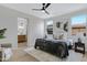 Relaxing bedroom with natural light, ceiling fan, ensuite bath, neutral decor and wooden floors at 19862 E Carriage Way, Queen Creek, AZ 85142