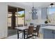 Dining area boasts modern light fixture and sliding glass doors leading to outdoor space, adjacent to well-appointed kitchen at 19862 E Carriage Way, Queen Creek, AZ 85142