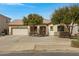 Charming single-story home featuring a well-maintained front yard with desert landscaping at 19862 E Carriage Way, Queen Creek, AZ 85142