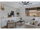 Comfortable living room featuring a ceiling fan, sofa, accent chair, and lots of light at 19862 E Carriage Way, Queen Creek, AZ 85142