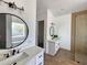 Bright bathroom with dual vanities, framed round mirrors, and a separate shower area at 2133 N Valley Dr, Apache Junction, AZ 85120