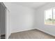 Simple bedroom with neutral carpet, white walls, and a window overlooking the front yard at 2133 N Valley Dr, Apache Junction, AZ 85120