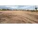 Spacious, undeveloped desert lot offering views of distant mountains and desert vegetation at 2133 N Valley Dr, Apache Junction, AZ 85120