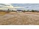 Expansive desert landscape featuring sparse vegetation and a newly built home in the distance at 2133 N Valley Dr, Apache Junction, AZ 85120