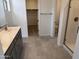 Bathroom features a modern vanity with double sinks, a glass-enclosed shower, and tile flooring at 23335 W Monona Ln, Surprise, AZ 85387