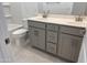 Well-lit bathroom featuring a double sink vanity, modern fixtures, and a clean, white toilet at 23335 W Monona Ln, Surprise, AZ 85387