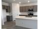 Modern kitchen featuring a large island, stainless steel appliances, stylish countertops, and ample cabinet space at 23335 W Monona Ln, Surprise, AZ 85387