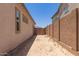 Side yard enclosed by block wall and metal gate, providing privacy at 23805 N 163Rd Dr, Surprise, AZ 85387
