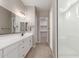 Modern bathroom with double vanity, tile floors and a glass-enclosed shower at 23805 N 163Rd Dr, Surprise, AZ 85387