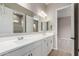 Bathroom featuring dual sinks, sleek countertops, and doorway to bedroom at 23805 N 163Rd Dr, Surprise, AZ 85387