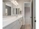 Bathroom featuring dual sinks, sleek countertops, and doorway to bedroom at 23805 N 163Rd Dr, Surprise, AZ 85387