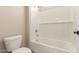 Bright bathroom with a white tiled shower-tub combo with chrome fixtures and white toilet at 23805 N 163Rd Dr, Surprise, AZ 85387