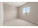 Bright bedroom with a large window and neutral colored walls and flooring at 23805 N 163Rd Dr, Surprise, AZ 85387
