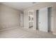 Bedroom featuring neutral carpet, slider door closet, and bathroom doorway at 23805 N 163Rd Dr, Surprise, AZ 85387