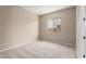 Bedroom featuring neutral carpet, window, and entry doorway at 23805 N 163Rd Dr, Surprise, AZ 85387