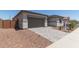 Charming home showcasing a modern garage and driveway pavers at 23805 N 163Rd Dr, Surprise, AZ 85387