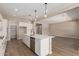 Open-concept kitchen with sleek appliances, an island, and access to the living area at 23805 N 163Rd Dr, Surprise, AZ 85387