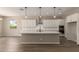 Modern kitchen with white cabinets, large island, and stainless steel appliances at 23805 N 163Rd Dr, Surprise, AZ 85387