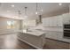 Bright kitchen with an island, breakfast bar, pendant lights, and stainless steel appliances at 23805 N 163Rd Dr, Surprise, AZ 85387