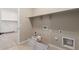 New laundry room with connections, shelving, and tile flooring ready for appliances at 23805 N 163Rd Dr, Surprise, AZ 85387