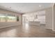 Open-concept living room and kitchen with a large island and white cabinets at 23805 N 163Rd Dr, Surprise, AZ 85387