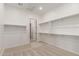Spacious walk-in closet with ample shelving and neutral carpeting at 23805 N 163Rd Dr, Surprise, AZ 85387