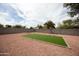 Large backyard featuring a patch of grass with gravel and block wall at 252 S Cholla St, Gilbert, AZ 85233