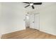 Spacious bedroom featuring a ceiling fan, closet, and doorway access at 252 S Cholla St, Gilbert, AZ 85233